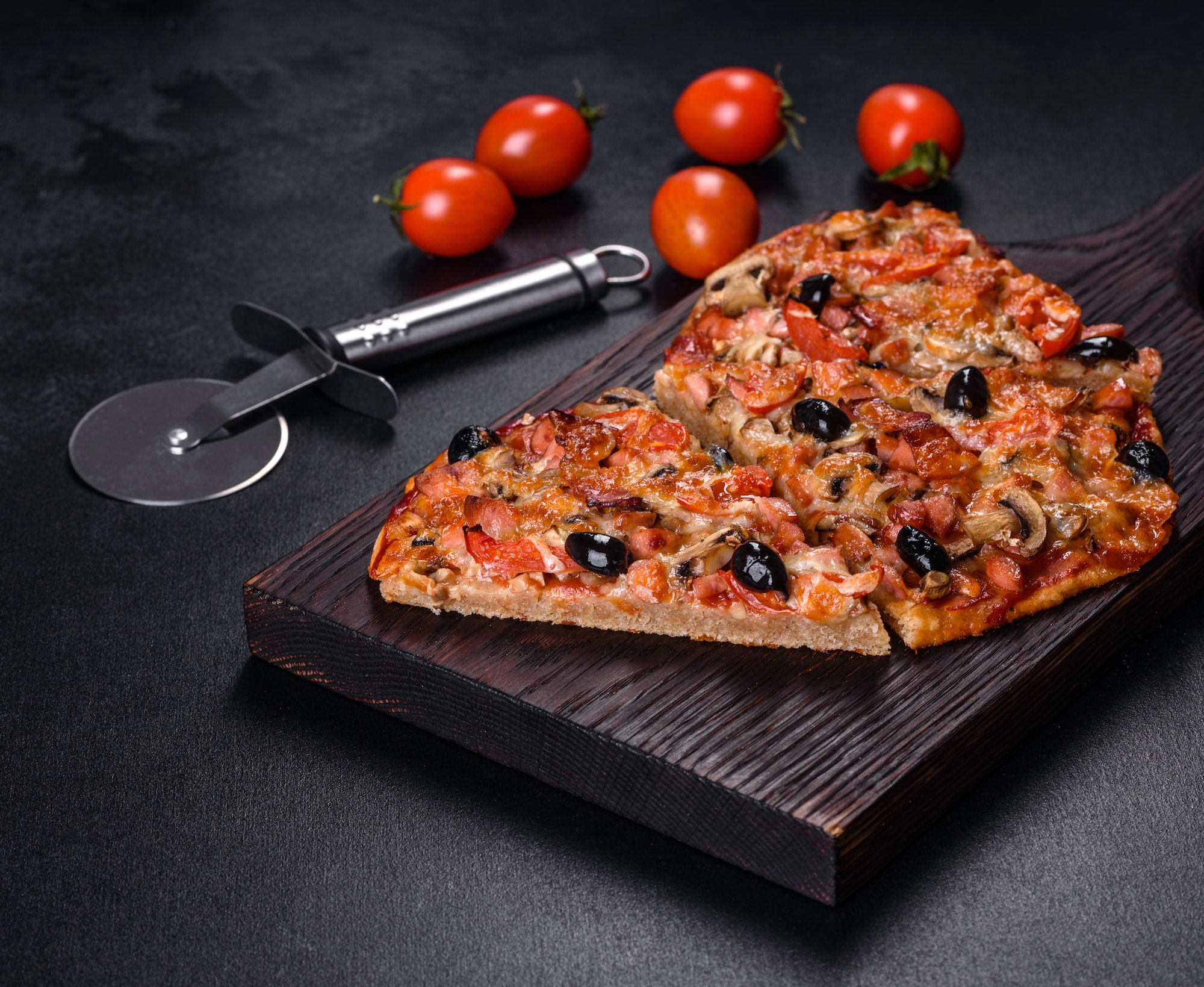 Homemade vegetable pizza with addition of tomatoes, olives and herbs